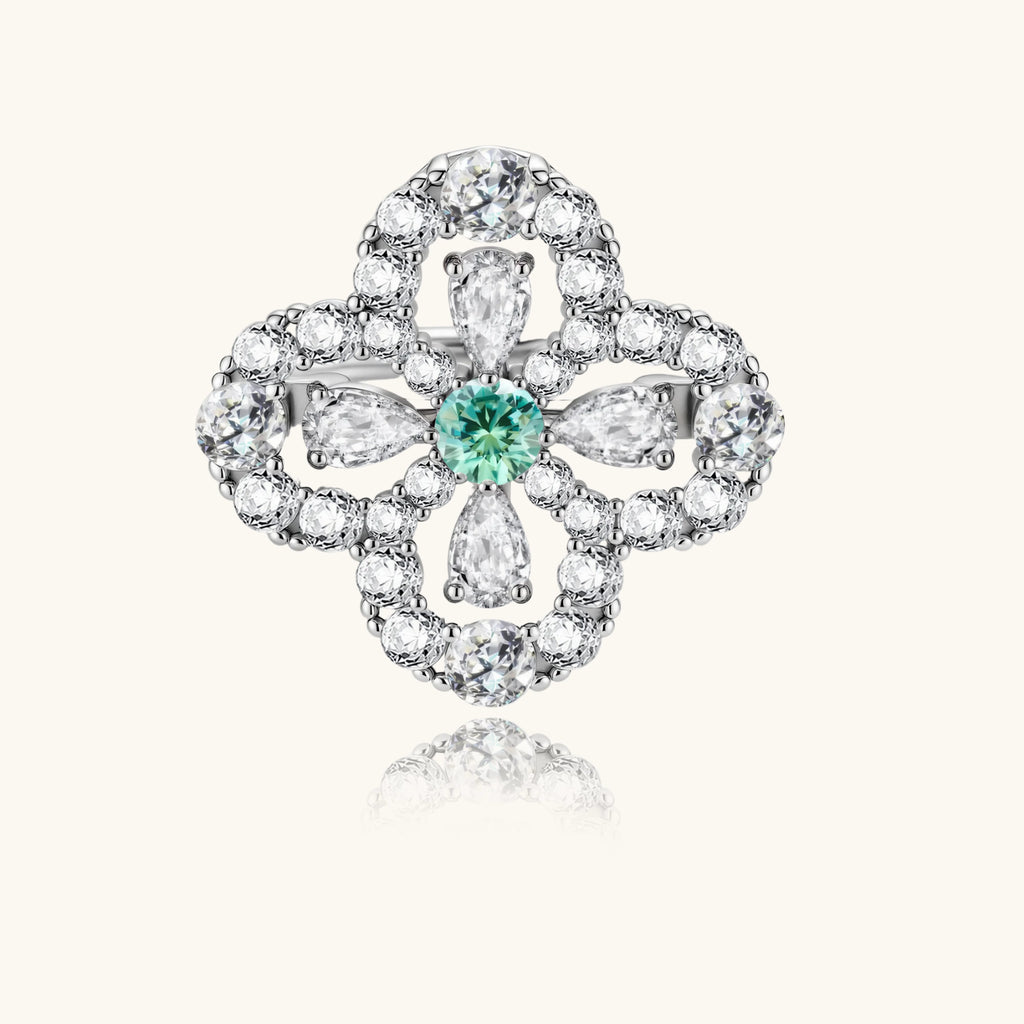 Sterling silver adjustable ring featuring four-leaf clover design with green center moissanite and clear accent stones