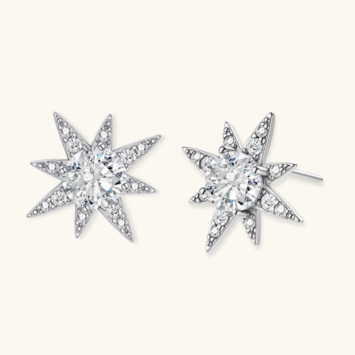 Sterling silver star-shaped stud earrings with brilliant moissanite center stones and pavé details on neutral background.