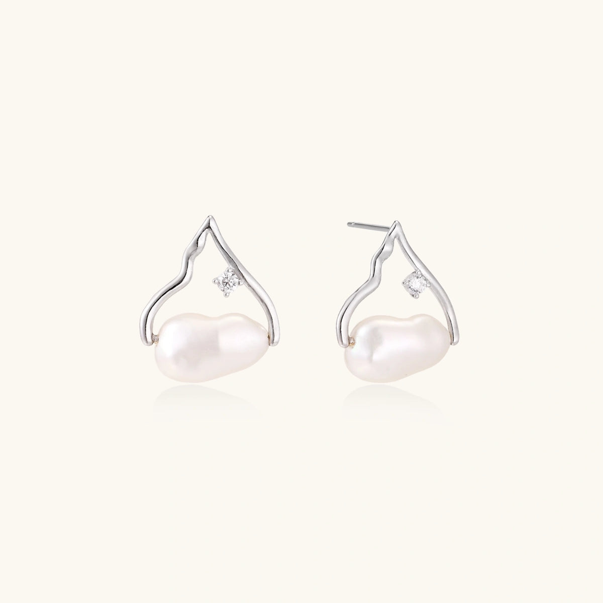 Silver mountain outline studs with baroque pearl and diamond accent on white background