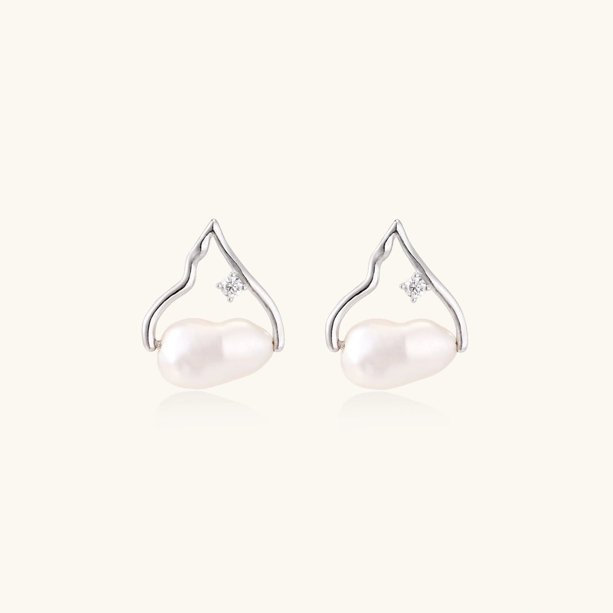 Silver mountain outline studs with baroque pearl and diamond accent on white background