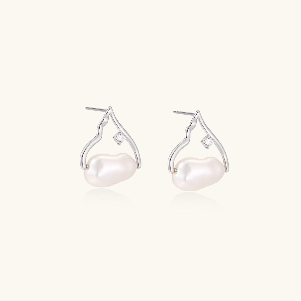 Silver mountain outline studs with baroque pearl and diamond accent on white background