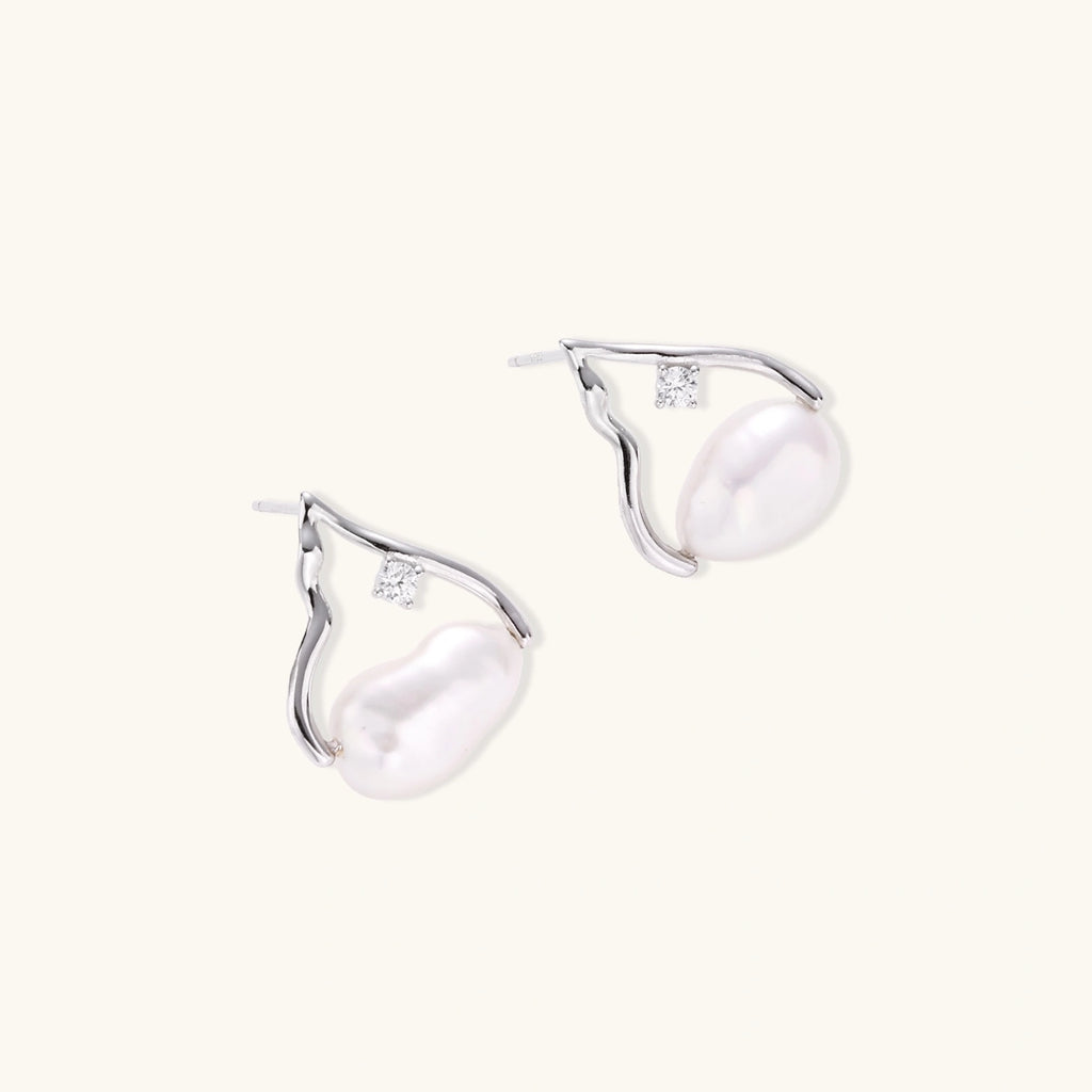 Silver mountain outline studs with baroque pearl and diamond accent on white background