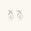 Rhodium-plated silver stud earrings with sparkling X design above lustrous round freshwater pearls on white background.