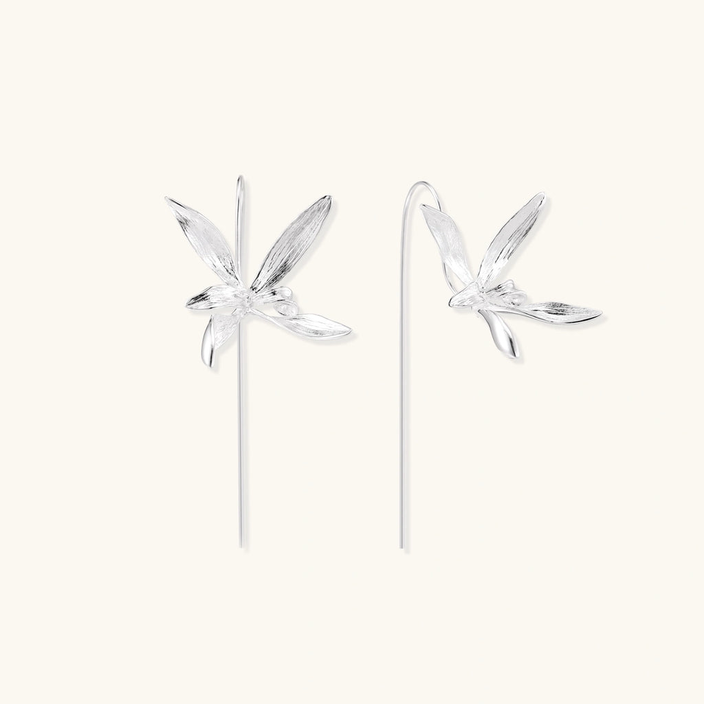 Delicate sterling silver dragonfly earrings with textured wings and curved threader hooks on white background
