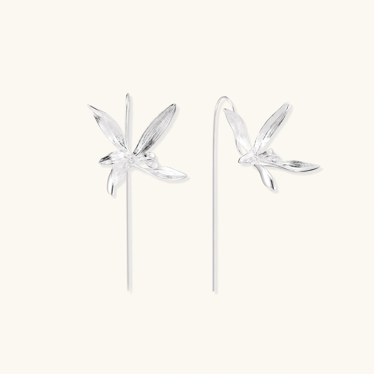 Delicate sterling silver dragonfly earrings with textured wings and curved threader hooks on white background