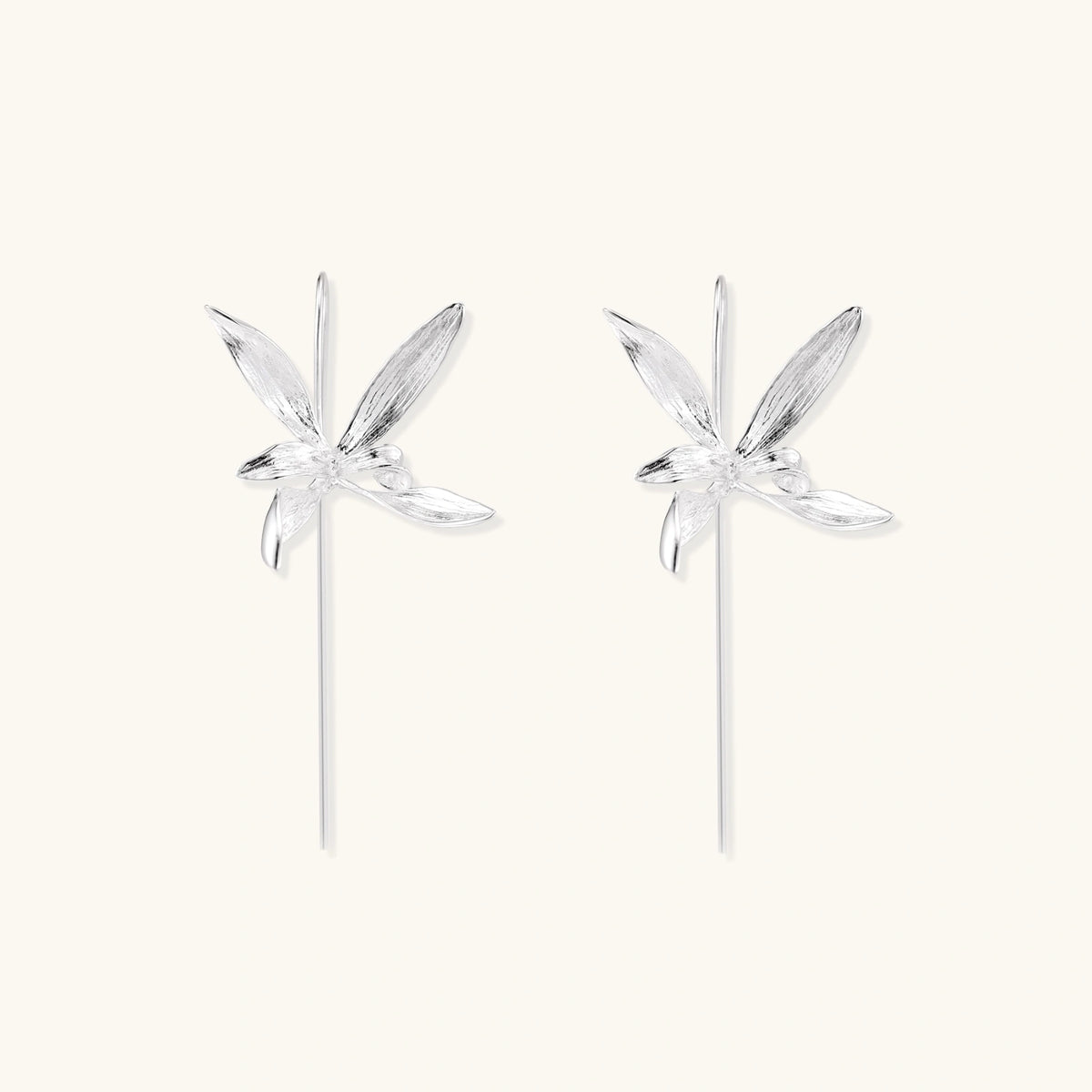 Delicate sterling silver dragonfly earrings with textured wings and curved threader hooks on white background