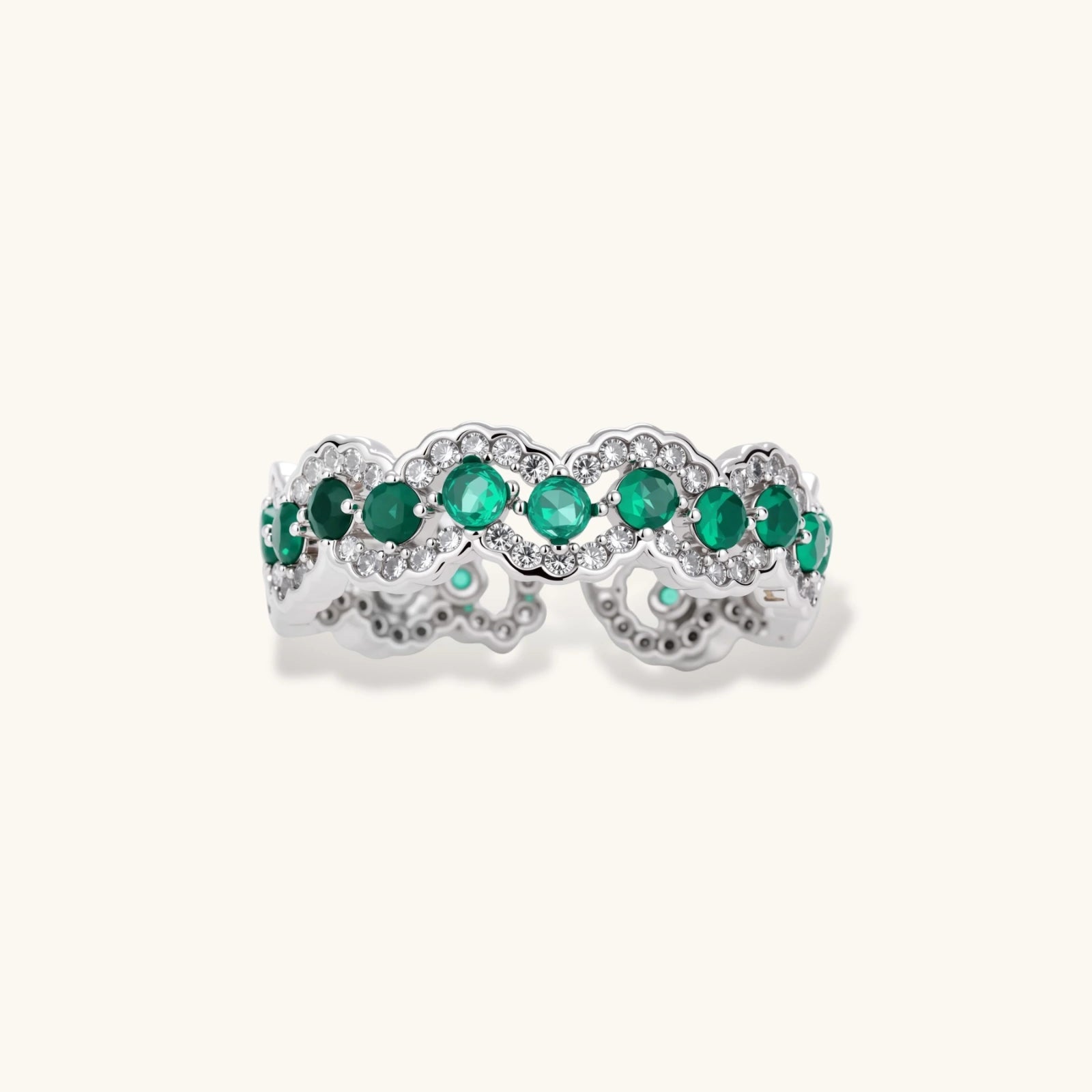 Platinum-plated copper ring with green zirconia stones in decorative scalloped wave pattern, adjustable band design.