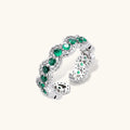 Platinum-plated copper ring with green zirconia stones in decorative scalloped wave pattern, adjustable band design.