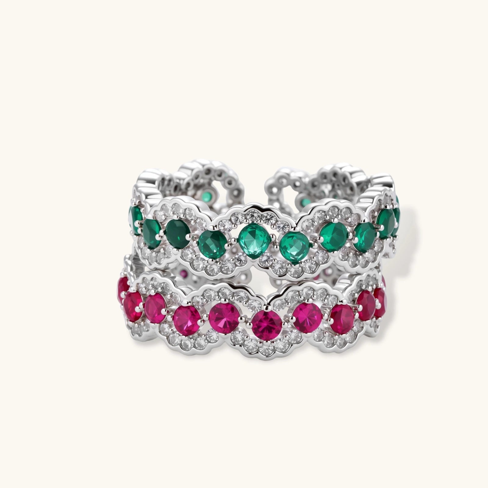 Platinum-plated copper ring with green zirconia stones in decorative scalloped wave pattern, adjustable band design.
